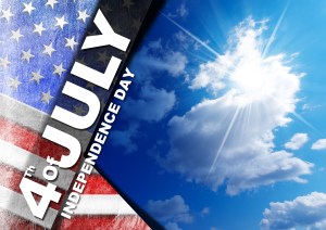 US flag on blue sky with clouds and sunlight with phrase 