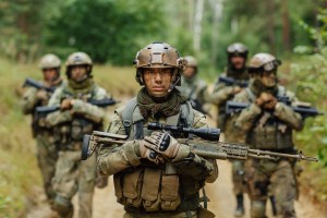 soldier stands with arms together with other